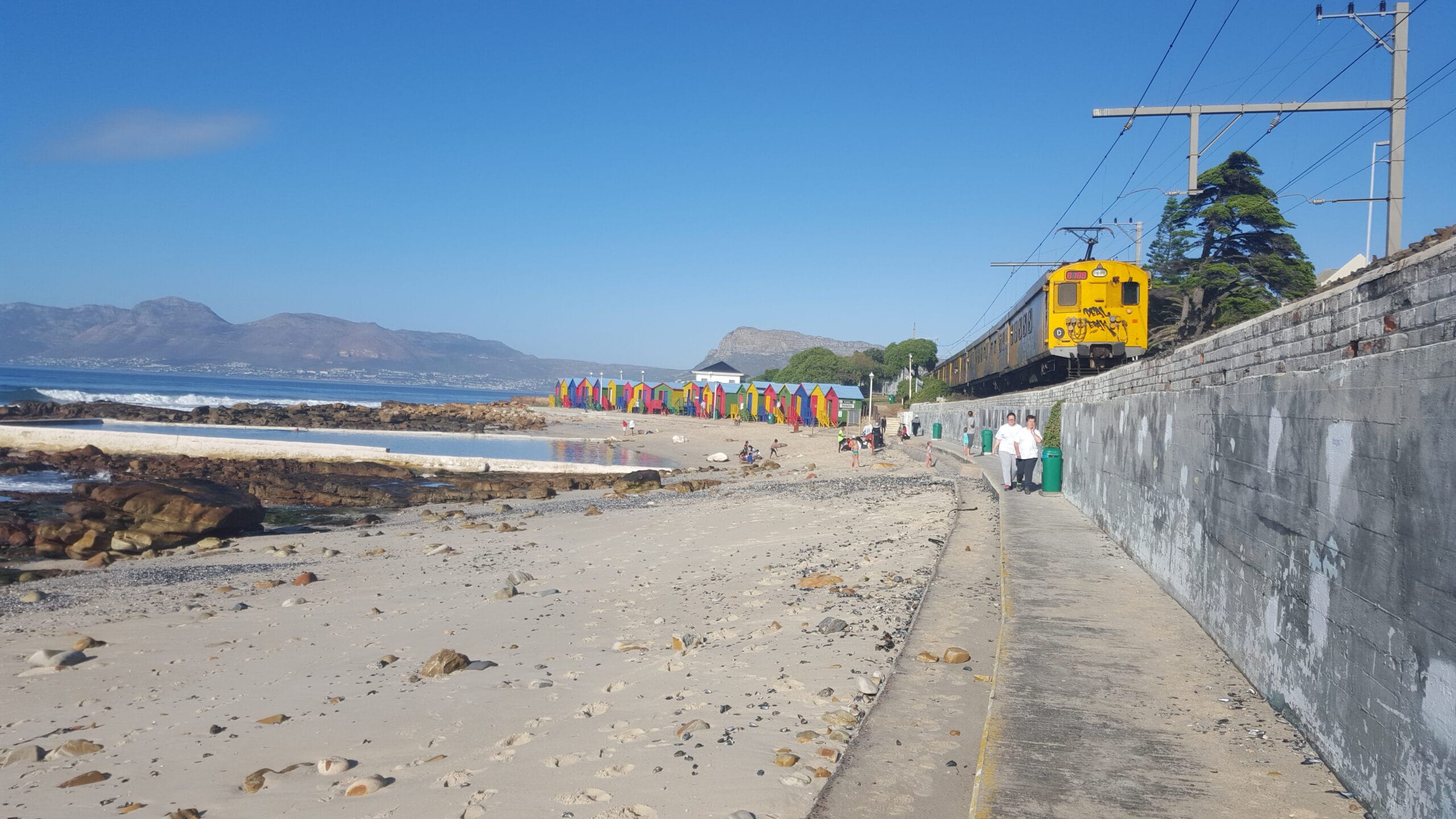 Southern Line train along the coast between St James and Kalk Bay, Cape Town