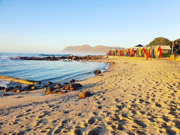 St James Beach colourful huts and mountain views